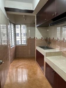 a kitchen with a sink and a counter top at Baridhara Sweet Home in Dhaka