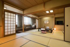 a japanese room with a living room and a room with at Nara Park Hotel in Nara