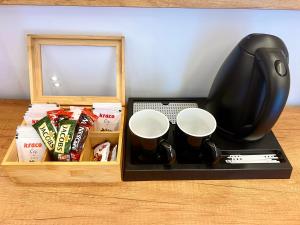 a tray with coffee cups and a computer mouse at ILLYRIAN hotel in Ksamil