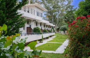 a building with a garden in front of it at Olga Rooms in Kanali