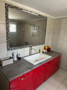 a bathroom with a sink and a large mirror at Marys holiday home 65sqm in Romanón