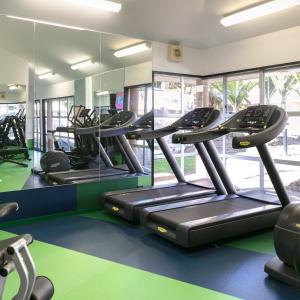 a gym with treadmills and elliptical machines at Naumi Auckland Airport Hotel in Auckland