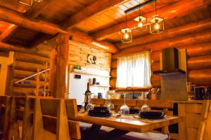 a dining room with a table and chairs in a cabin at Villa Korina in Fužine