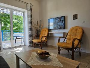 a living room with two chairs and a table at Holiday House 3- Kallithea Halkidiki in Kallithea Halkidikis
