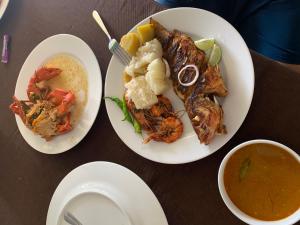 two plates of food with shrimp and a bowl of soup at Flexi Lodge in Negombo +44 photos