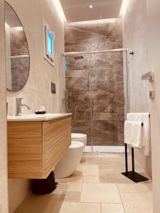 a bathroom with a shower and a toilet and a sink at LIMU casa vacanze in Lampedusa +30 photos