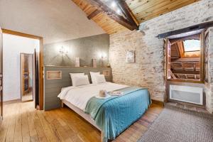 a bedroom with a bed with a table in it at Lou Papagai in Saint-Antonin +61 photos
