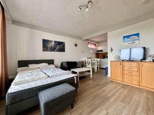 a bedroom with a bed and a living room at Haus Atlantic Whg. 514 in Cuxhaven