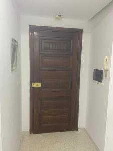 a brown door in a room with a wall at S1 La ain zaghouen nord in La Marsa