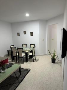 a dining room with a table and chairs at S1 La ain zaghouen nord in La Marsa