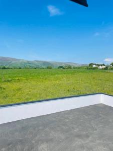 a view of a field from the roof of a house at De Búrca Cottage KERRY in Brackhill +3 photos
