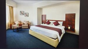 a hotel room with a bed and a couch at Presidency Kochi City Centre in Cochin +78 photos