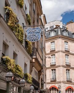 a sign on the side of a building at Hôtel De Buci in Paris