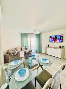 a living room with a glass table and chairs at BLUE PLATAN Apartment in Salou