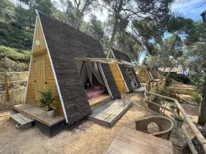 a group of small houses in a yard at Glamping Lodge Estartit in L'Estartit
