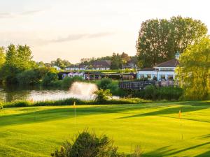 a view of a golf course with a pond at Drift Inn at Wyboston Lakes in Saint Neots