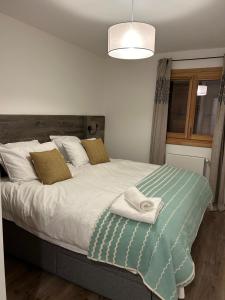 a bedroom with a bed with towels on it at Les Chalets de Montriond B101 in Montriond