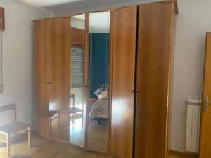 a large wooden cabinet in a room at Appartamento 300m dal mare AMANTEA CALABRIA in Amantea