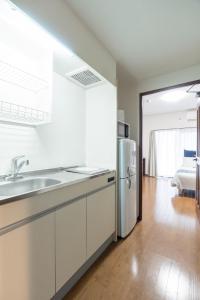 a kitchen with a sink and a refrigerator at Grande es TENJIN in Fukuoka +189 photos