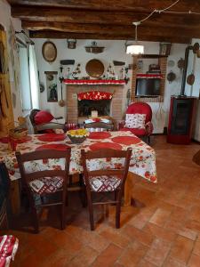 a living room with a table and chairs and a fireplace at La Stazion in Paderno