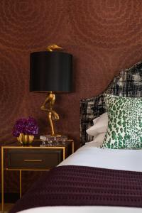 a bedroom with a bed and a lamp on a nightstand at The Merchant in Salem