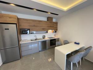 a kitchen with a counter and a table and chairs at SA Apartments! 1bd Flat 300m to the Beach in Alanya