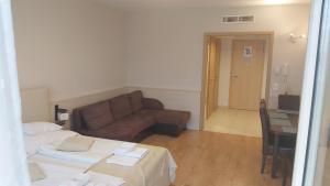 a living room with a couch and a table at Wellness Apartments in Velence in Velence