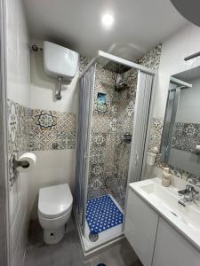 a bathroom with a shower and a toilet and a sink at Sermoneta10 in Naples +4 photos