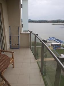 a balcony with a view of the water at Wellness Apartments in Velence in Velence