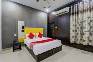 a bedroom with a large bed with red pillows at OYO Flagship Ideal Inn in Lucknow