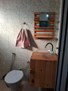 a bathroom with a sink and a toilet and a sink at Cute Rustic Cottage by the River in Caximba +97 photos