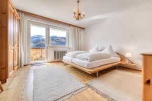 a bedroom with a bed and a large window at Ferienhaus Walter in Nüziders +26 photos