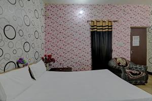 A bed or beds in a room at OYO The Home