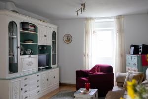 a living room with a large white entertainment center at Casa San Martiño - Teo in Rua De Francos