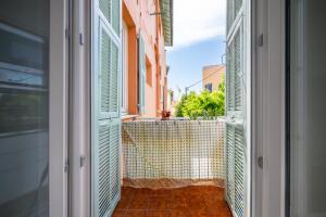 an open door with a view of a balcony at Pink Palace - Quartier Authentique Libération in Nice
