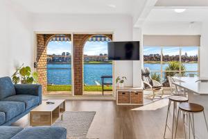 a living room with a view of the water at Lakeside Mews in Grange