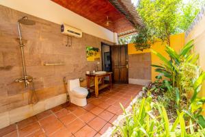 a bathroom with a toilet and a shower at Dugong Resort Phu Quoc in Phu Quoc