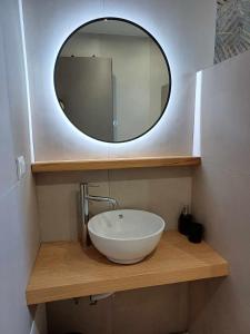 a bathroom with a sink and a mirror at Romeos Studios in Agia Marina Nea Kydonias