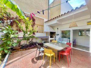 a patio with a table and colorful chairs at Macarena House & Chill Out in Benidorm