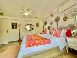 a bedroom with a large bed and a ceiling fan at Macarena House & Chill Out in Benidorm