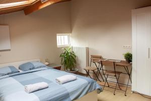 a bedroom with a bed and a table and chairs at B&B Wasboerderij Beek Ubbergen in Beek
