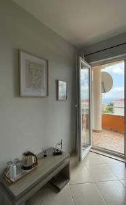 a living room with a table and a sliding glass door at Villa Ivanovic in Budva