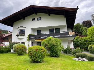 a white house with a black roof at Haus Beatrice in Kitzbühel