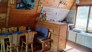 a dining room with a table and chairs in a cabin at Domek letniskowy in Antonowo +7 photos