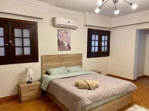 a bedroom with a bed with two pillows on it at New Maadi Apartment Families Only in Cairo