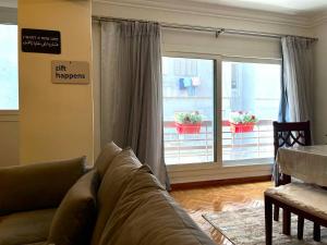 a living room with a couch and a window at New Maadi Apartment Families Only in Cairo