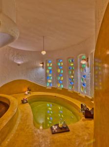 a bathroom with a green tub in a room at The Earth at Ranthambore in Sawāi Mādhopur