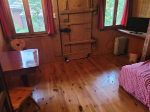 a room with a wooden floor and a wooden door at aschis Lodge 2 in Soubey