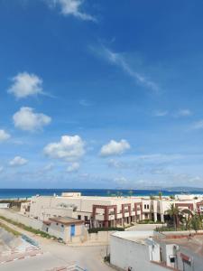 a view of the beach from the balcony of a building at Villa Kyan with private pool in Bizerte
