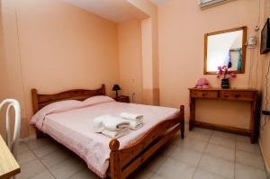a bedroom with a bed with a dog laying on it at Paradise Studios in Svoronata